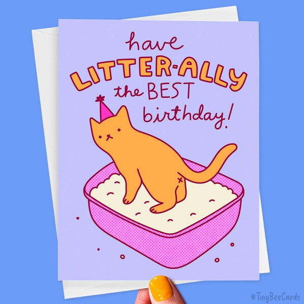 Birthday card with an illustration of a cat in the litter box and text saying "Have LITTER-ALLY the BEST Birthday!" on a blue background.