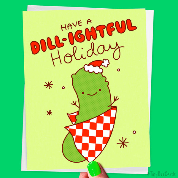 Hand drawn greeting card with a cute dill pickle character and text 'Have a DILL-IGHTFUL Holiday' on a green background.