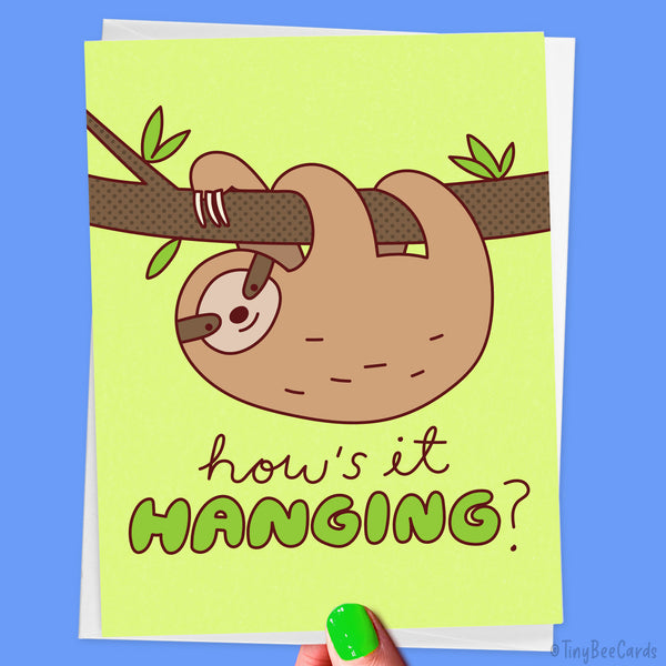 Greeting card with a sloth illustration and text 'how's it HANGING?' on a green background.