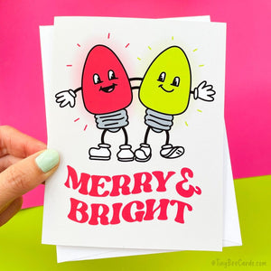 A Retro Christmas Lights Holiday Card with two cartoon holiday lights with arms around each other's backs, and the pun text "Merry and Bright"